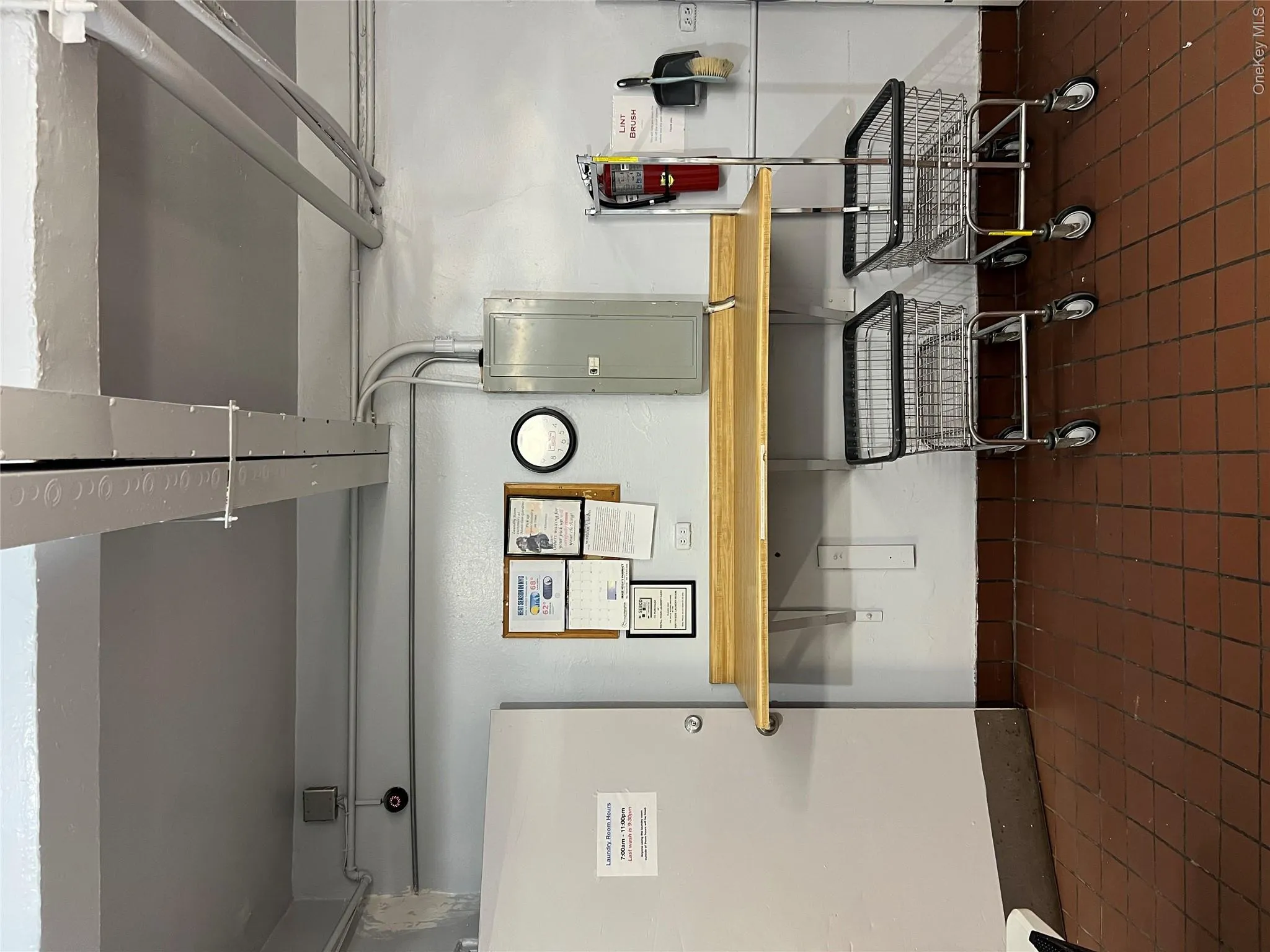Basement featuring electric panel and dark tile patterned floors Basement featuring electric panel and dark tile patterned floors