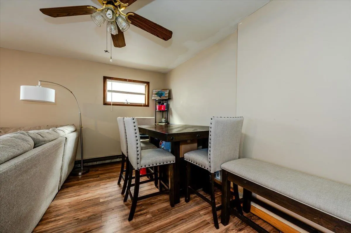 Dining area featuring ceiling fan and dark hardwood / wood-style floors Dining area featuring ceiling fan and dark hardwood / wood-style floors