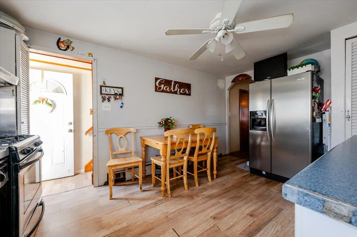 Dining room with ceiling fan and light wood-type flooring Dining room with ceiling fan and light wood-type flooring