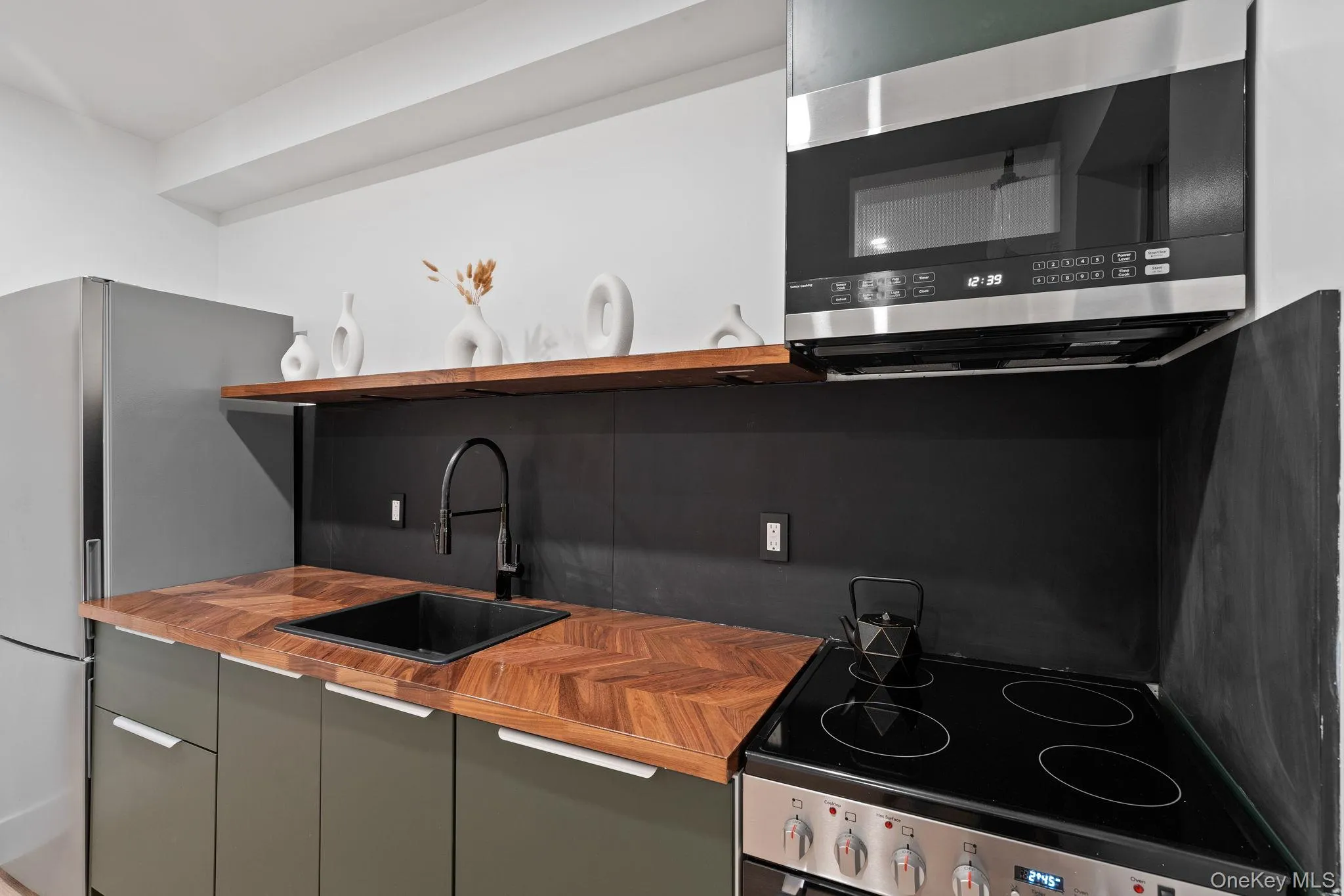 Kitchen with sink and stainless steel appliances Kitchen with sink and stainless steel appliances