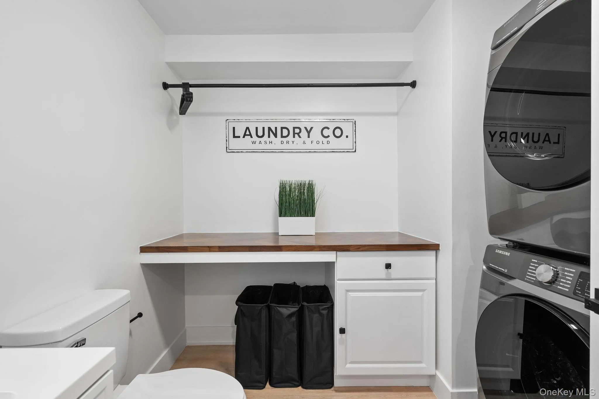 Laundry room with cabinets and stacked washing maching and dryer Laundry room with cabinets and stacked washing maching and dryer