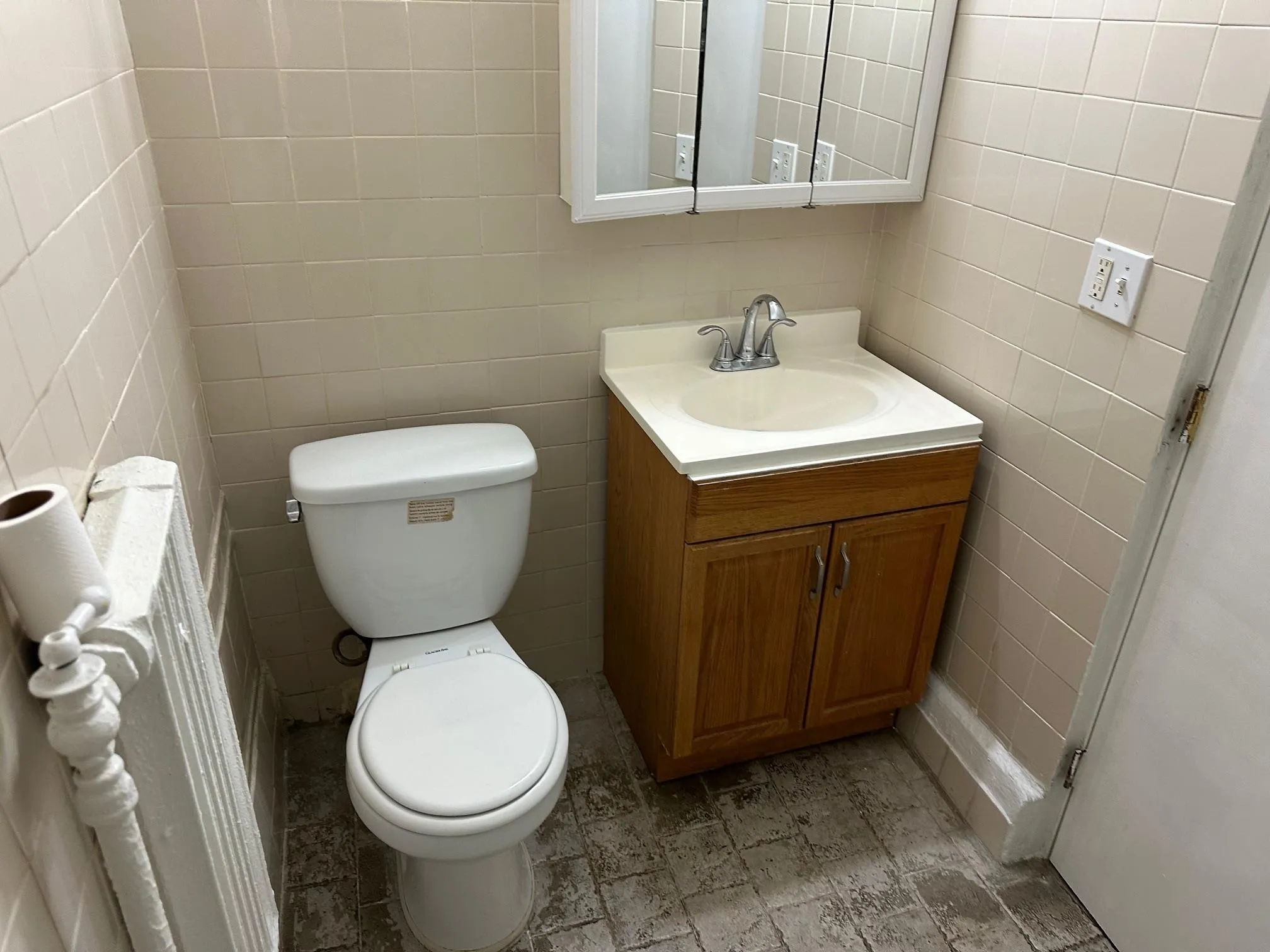 Bathroom featuring vanity, tile walls, and toilet Bathroom featuring vanity, tile walls, and toilet