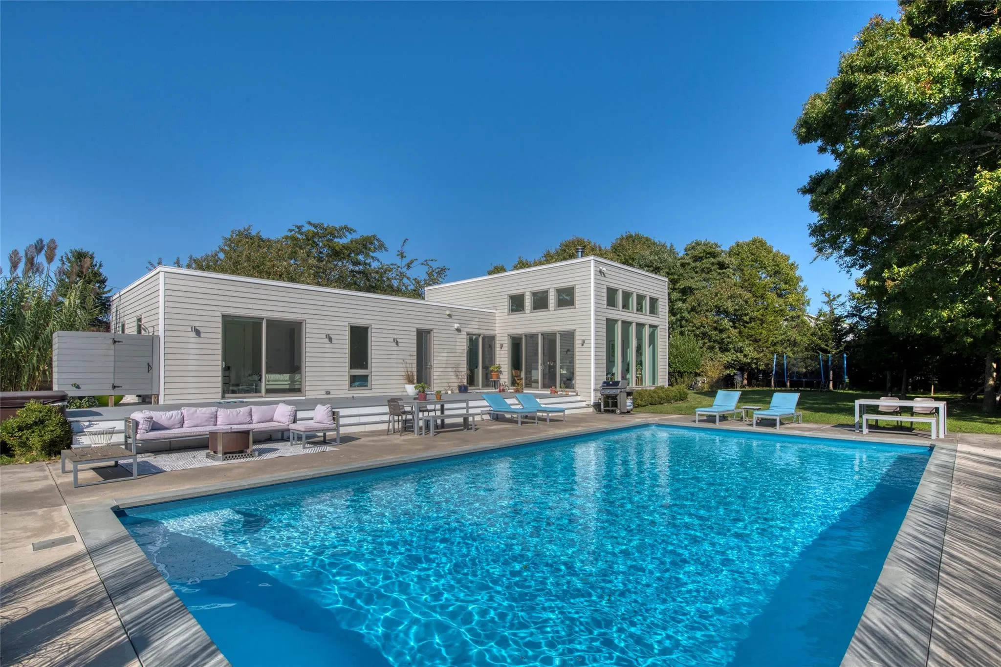 View of swimming pool featuring an outdoor living space, area for grilling, and a patio area View of swimming pool featuring an outdoor living space, area for grilling, and a patio area