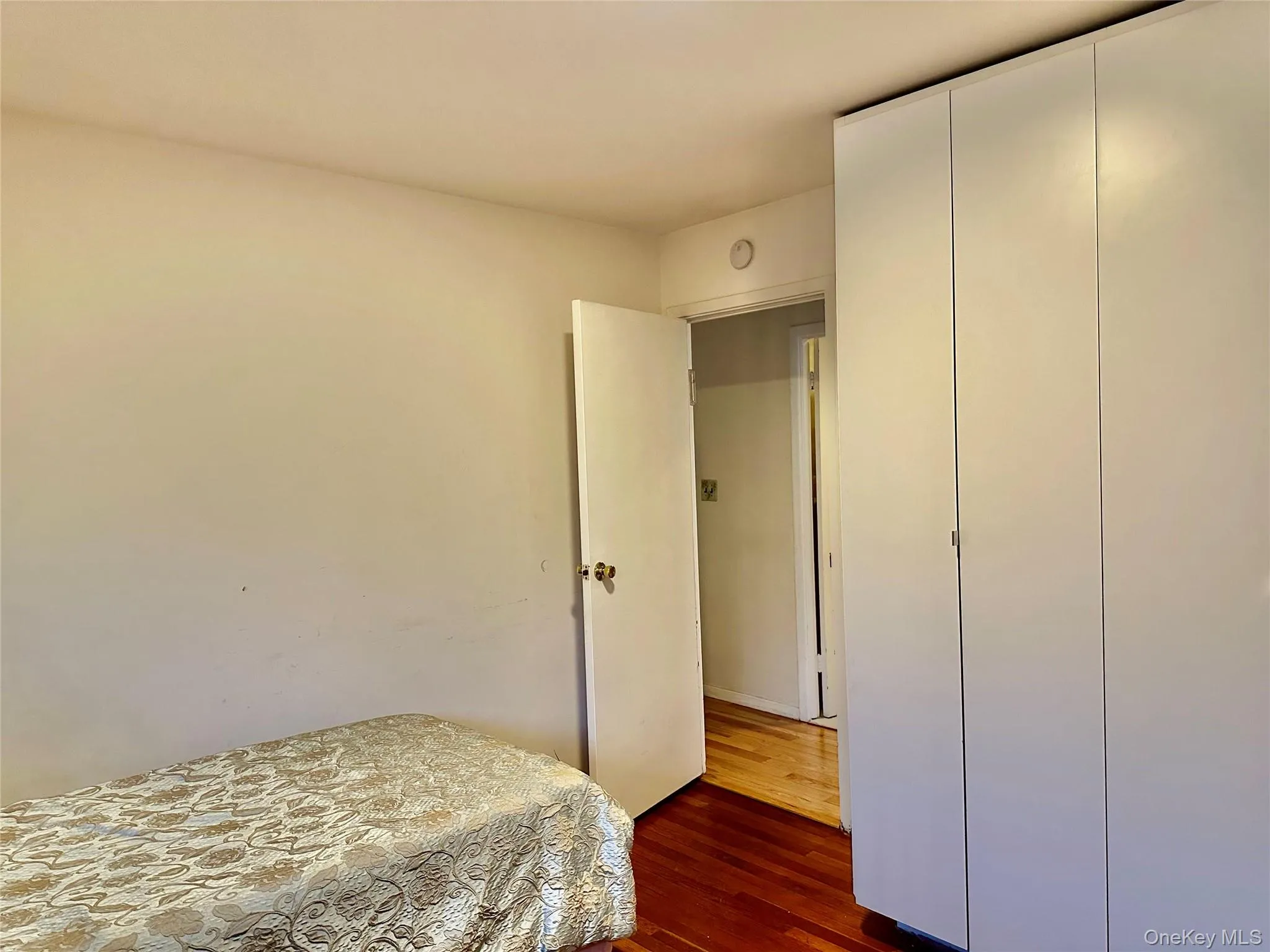 Bedroom featuring dark hardwood / wood-style floors Bedroom featuring dark hardwood / wood-style floors