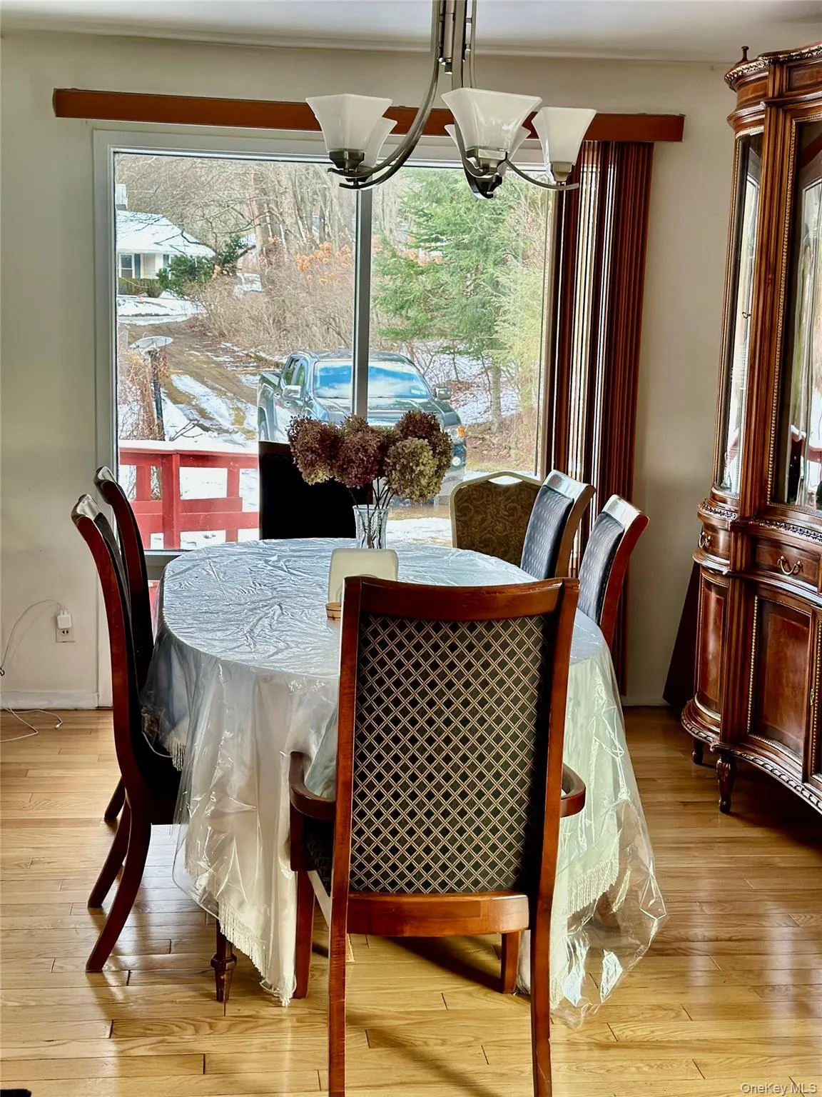 Dining area featuring light wood-type flooring and a notable chandelier Dining area featuring light wood-type flooring and a notable chandelier