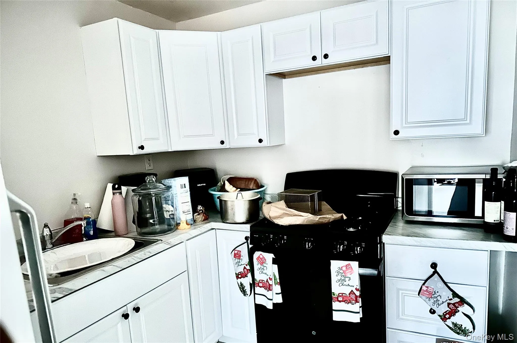 Kitchen with white cabinetry and sink Kitchen with white cabinetry and sink