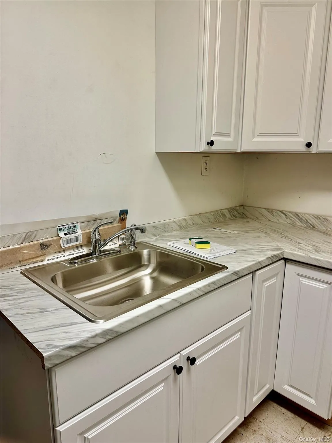 Kitchen featuring white cabinetry and sink Kitchen featuring white cabinetry and sink