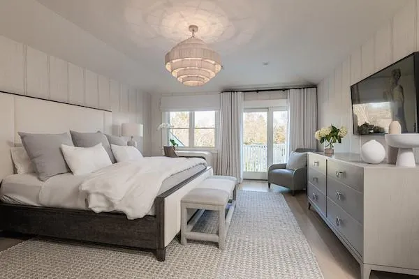 Bedroom featuring light hardwood / wood-style floors, access to exterior, and an inviting chandelier Bedroom featuring light hardwood / wood-style floors, access to exterior, and an inviting chandelier