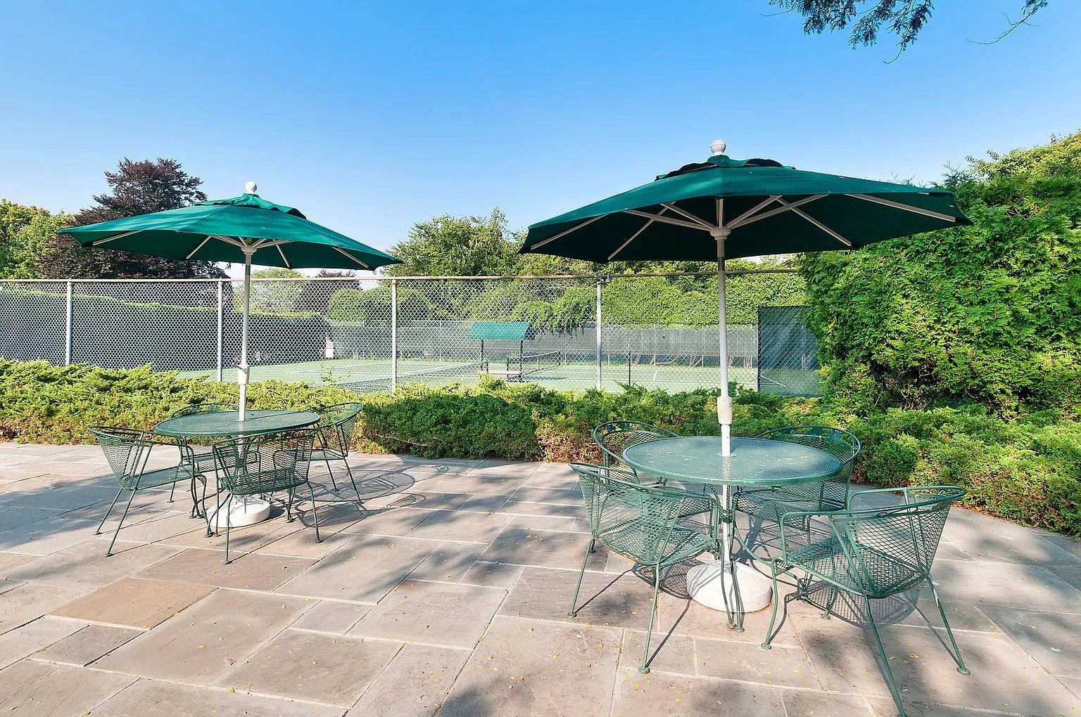 View of patio featuring tennis court View of patio featuring tennis court