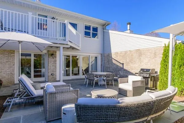 Rear view of house featuring an outdoor hangout area and a balcony Rear view of house featuring an outdoor hangout area and a balcony