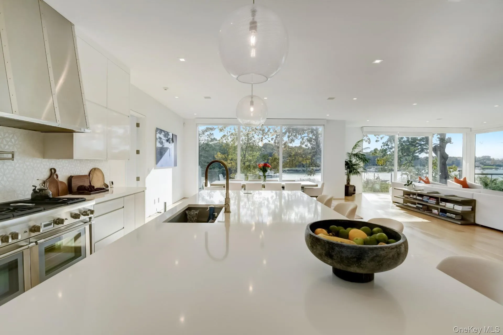 Kitchen with high end range, decorative light fixtures, plenty of natural light, and sink Kitchen with high end range, decorative light fixtures, plenty of natural light, and sink