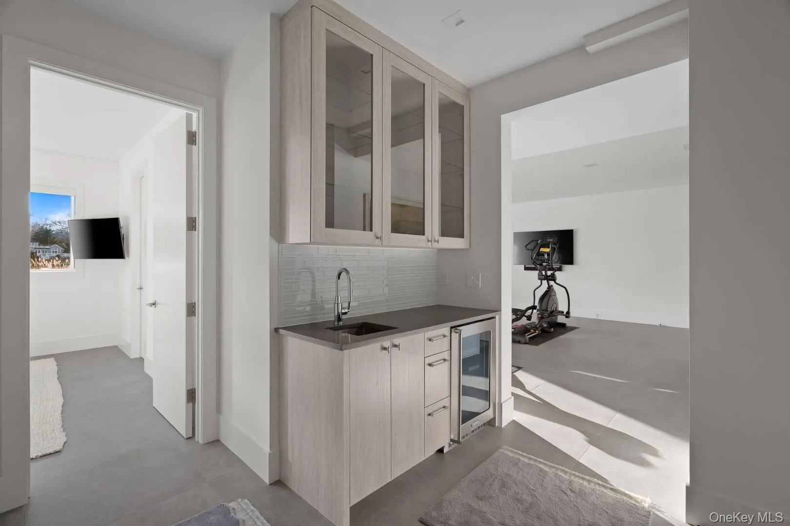 Bar featuring tasteful backsplash, wine cooler, and sink Bar featuring tasteful backsplash, wine cooler, and sink