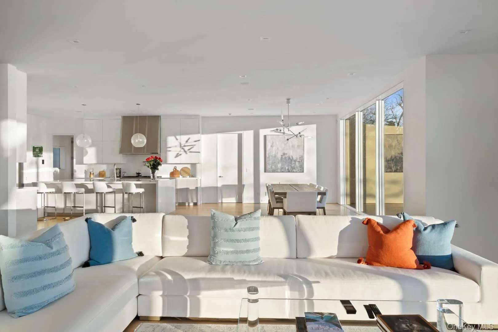 Living room with light hardwood / wood-style floors and an inviting chandelier Living room with light hardwood / wood-style floors and an inviting chandelier