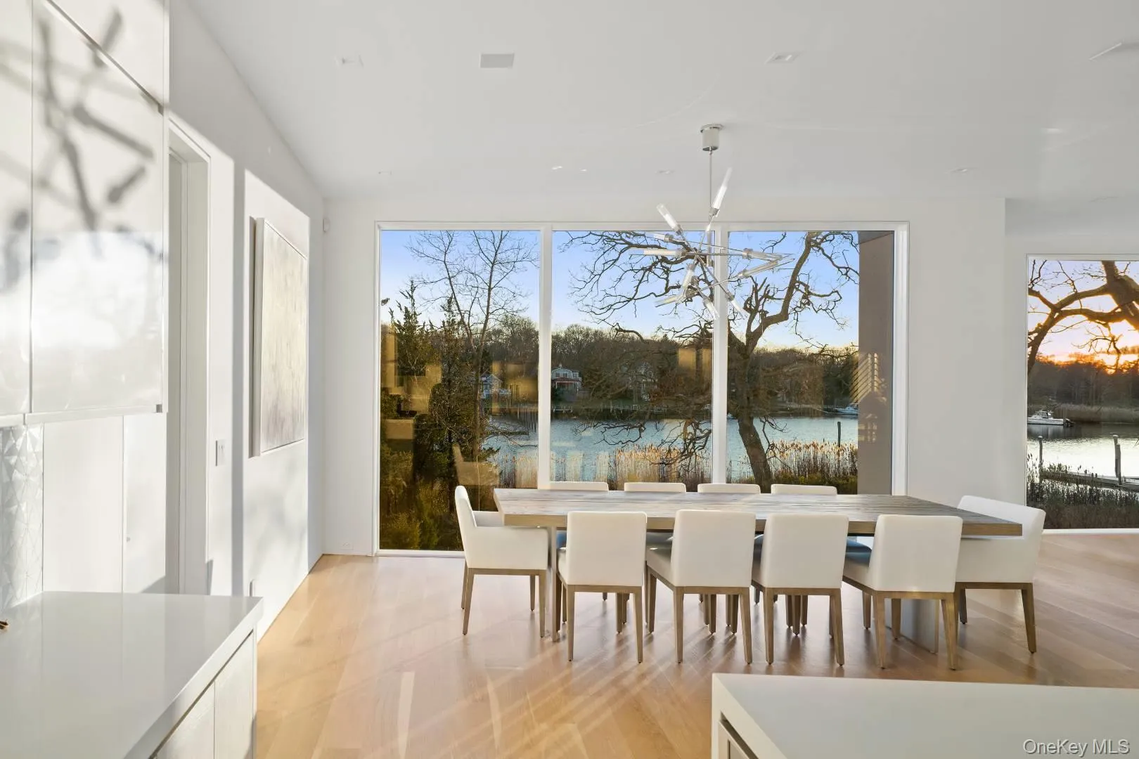 Dining room featuring a healthy amount of sunlight and a water view Dining room featuring a healthy amount of sunlight and a water view