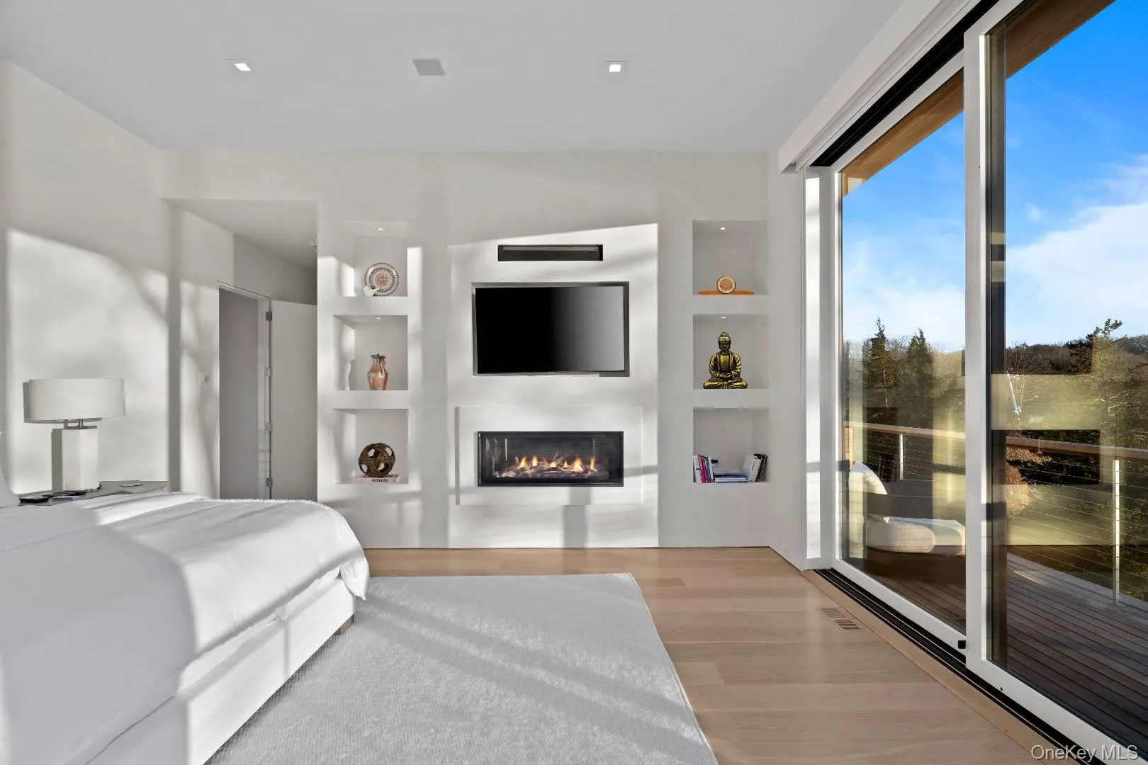 Bedroom with access to exterior and light hardwood / wood-style flooring Bedroom with access to exterior and light hardwood / wood-style flooring