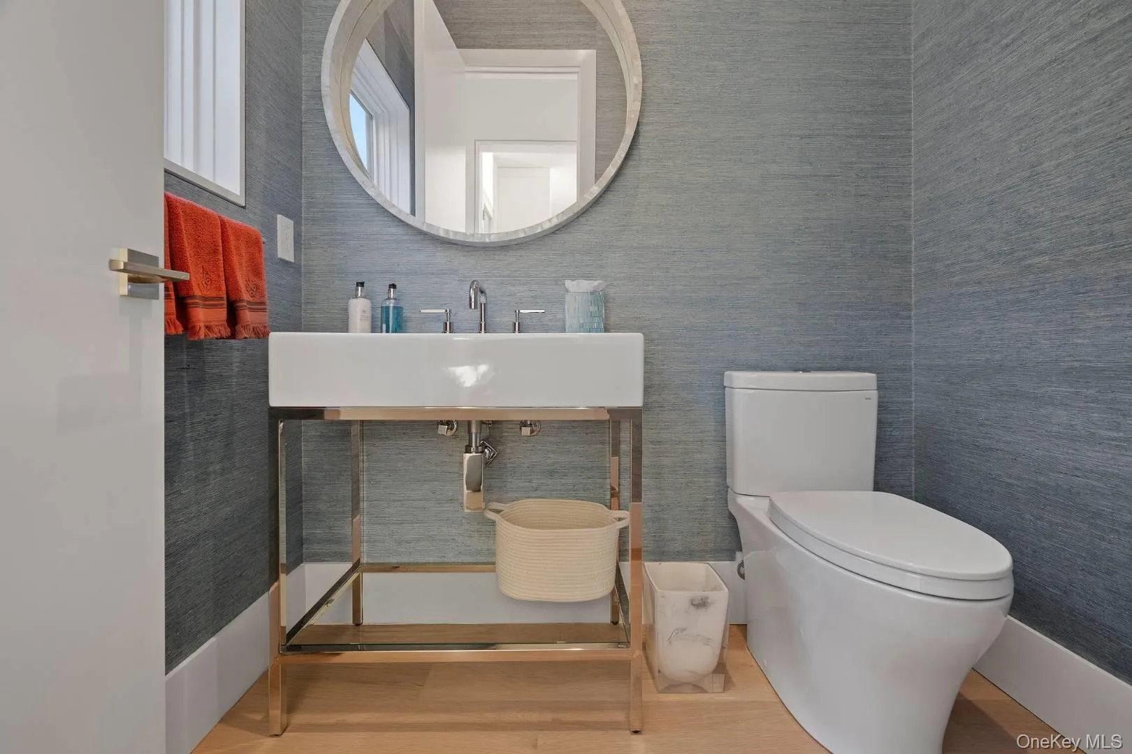 Bathroom with toilet, wood-type flooring, and sink Bathroom with toilet, wood-type flooring, and sink