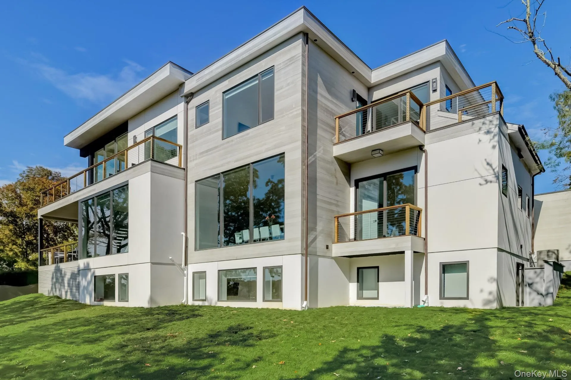 Rear view of house with a lawn and a balcony Rear view of house with a lawn and a balcony