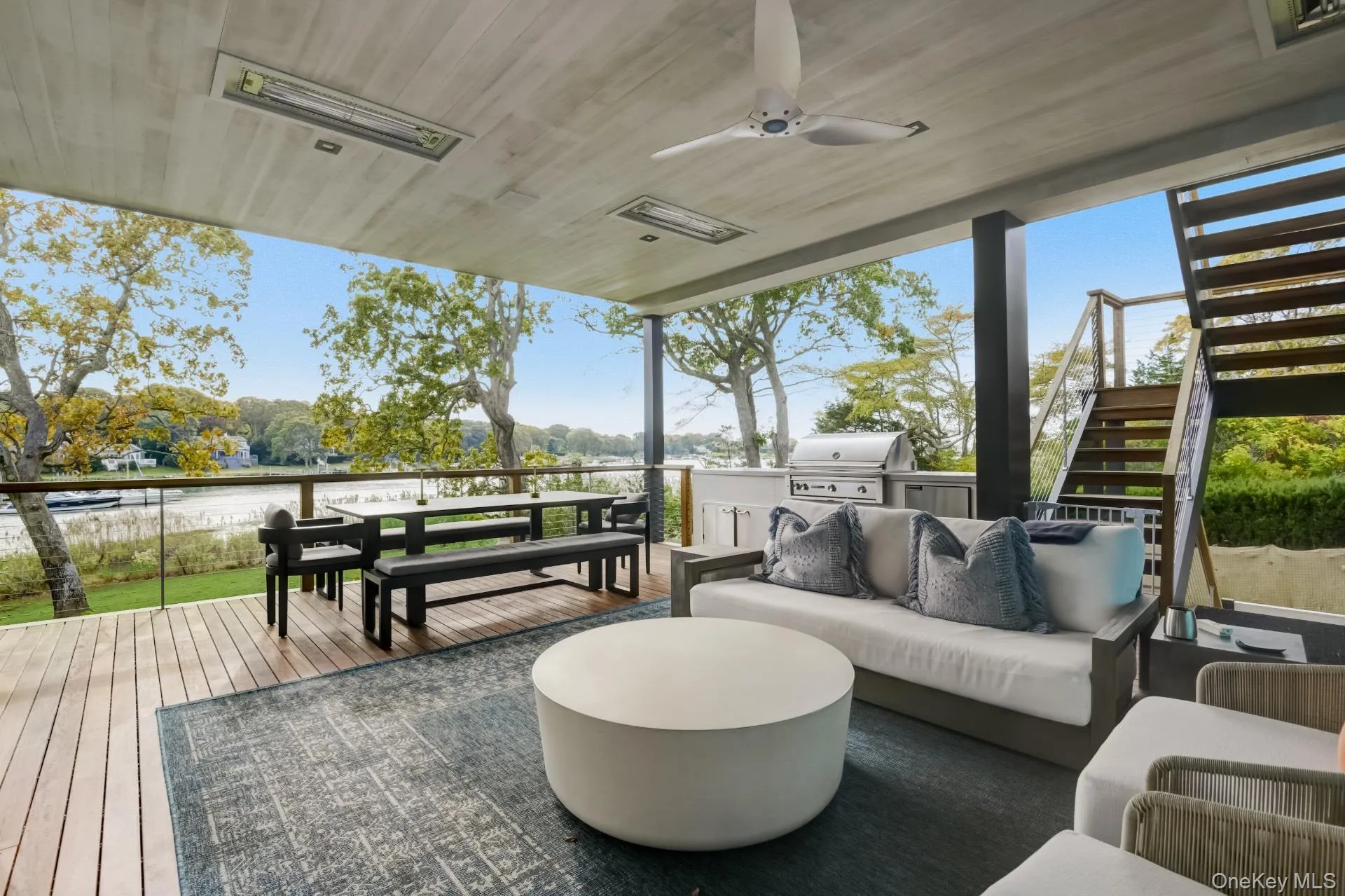 Deck with outdoor lounge area, a water view, ceiling fan, a grill, and exterior kitchen Deck with outdoor lounge area, a water view, ceiling fan, a grill, and exterior kitchen