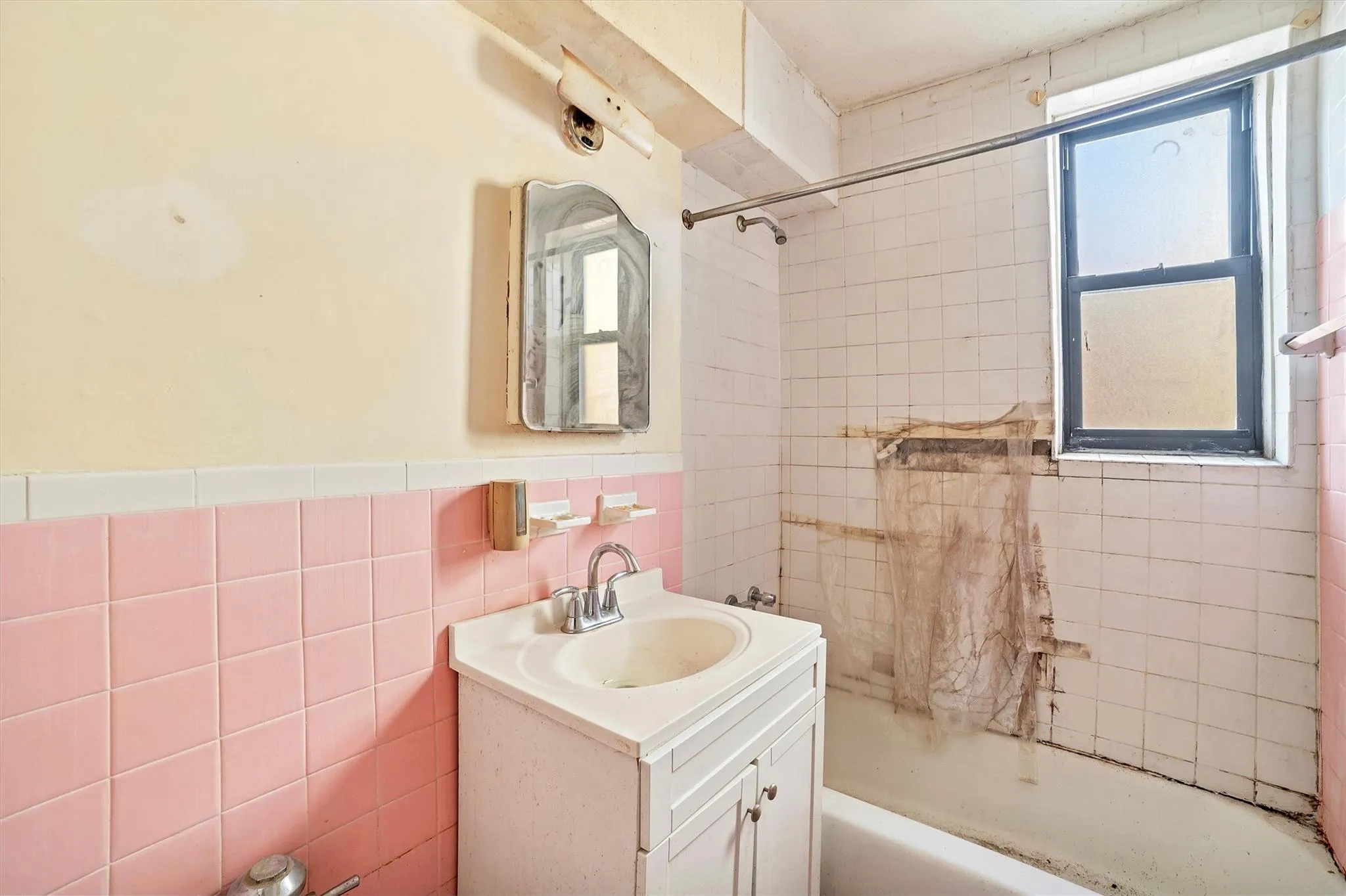 Bathroom featuring tile walls, tiled shower / bath combo, and vanity Bathroom featuring tile walls, tiled shower / bath combo, and vanity