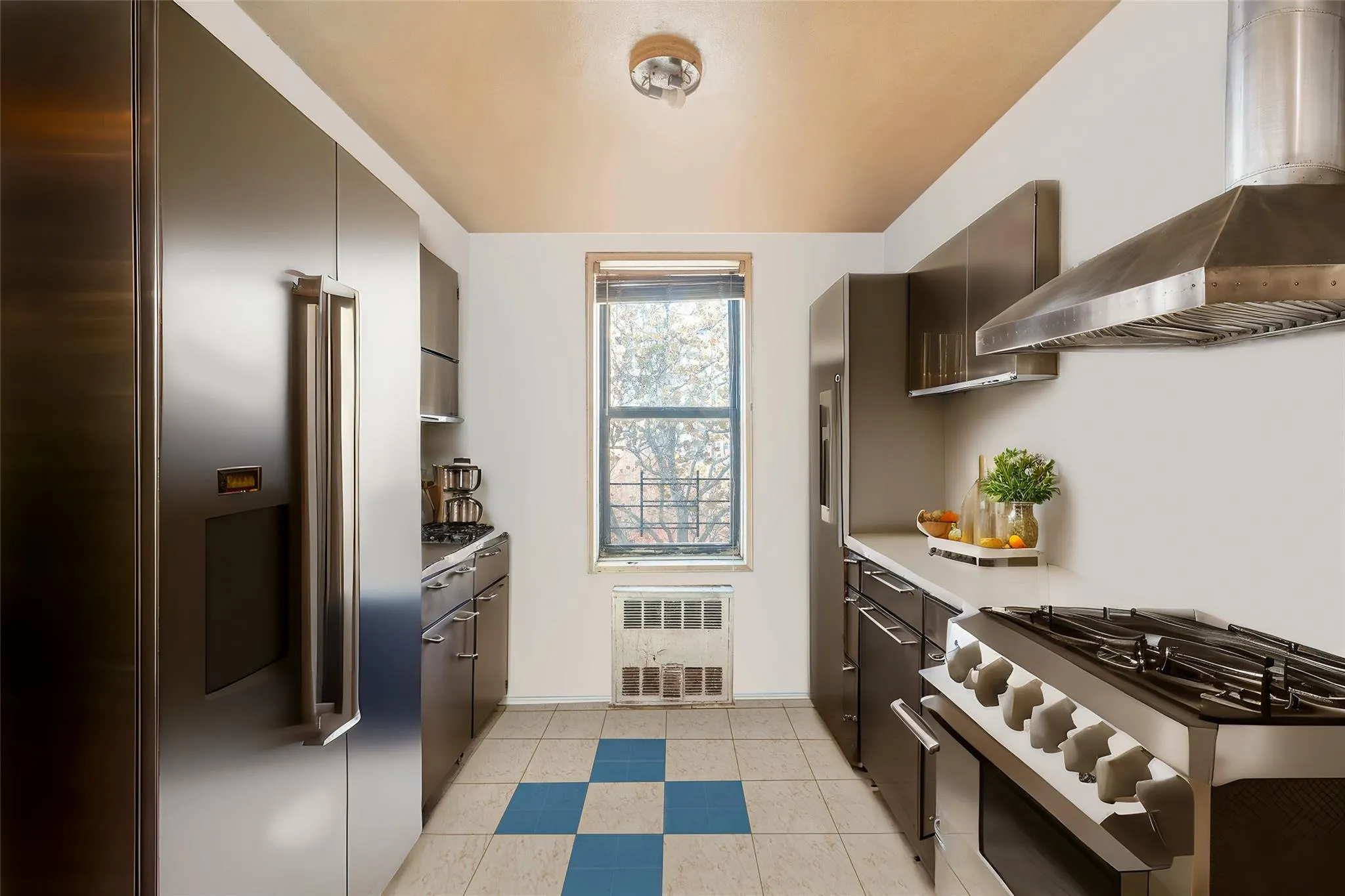 *Virtually Staged Kitchen featuring stainless steel appliances, wall chimney exhaust hood, and light tile patterned flooring *Virtually Staged Kitchen featuring stainless steel appliances, wall chimney exhaust hood, and light tile patterned flooring