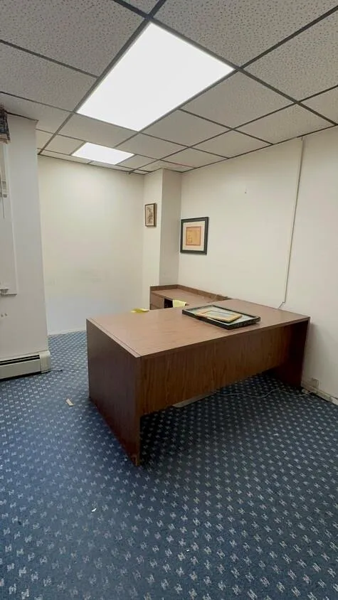 Unfurnished office with a drop ceiling and carpet Unfurnished office with a drop ceiling and carpet