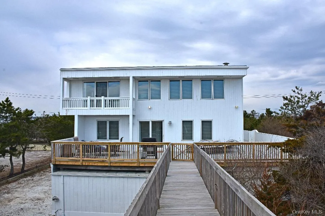 Rear view of house featuring a balcony Rear view of house featuring a balcony