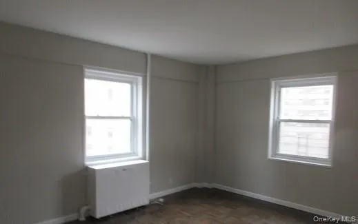 Spare room featuring dark parquet flooring Spare room featuring dark parquet flooring
