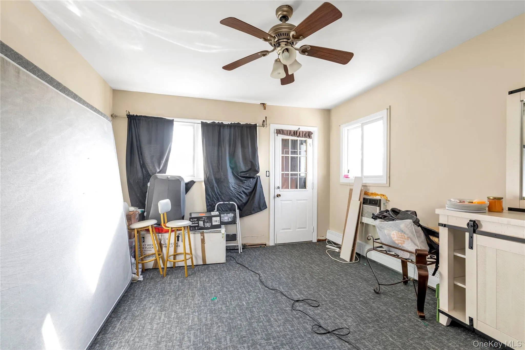 Miscellaneous room with ceiling fan and dark carpet Miscellaneous room with ceiling fan and dark carpet