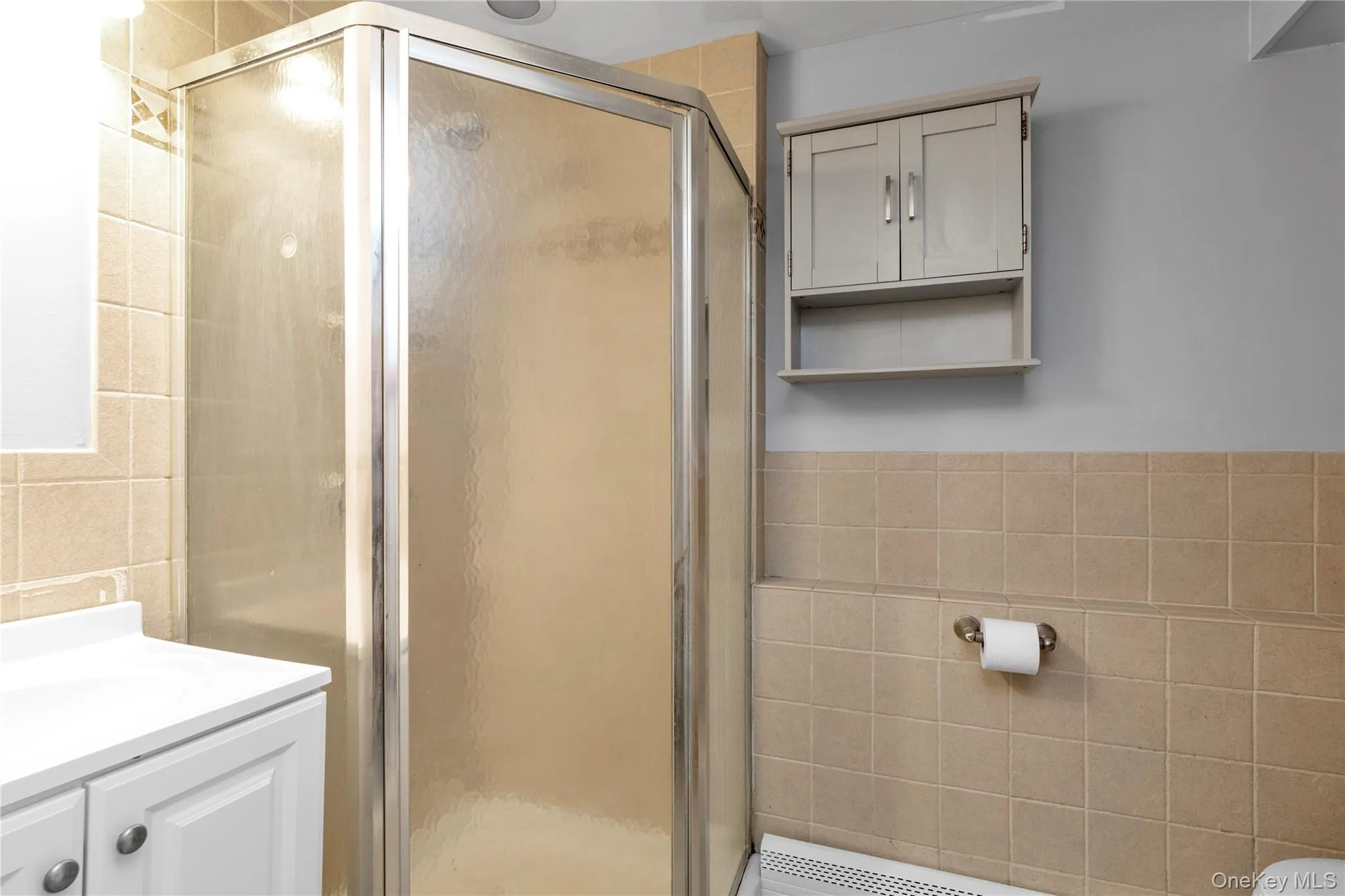 Bathroom with vanity and a shower with shower door Bathroom with vanity and a shower with shower door