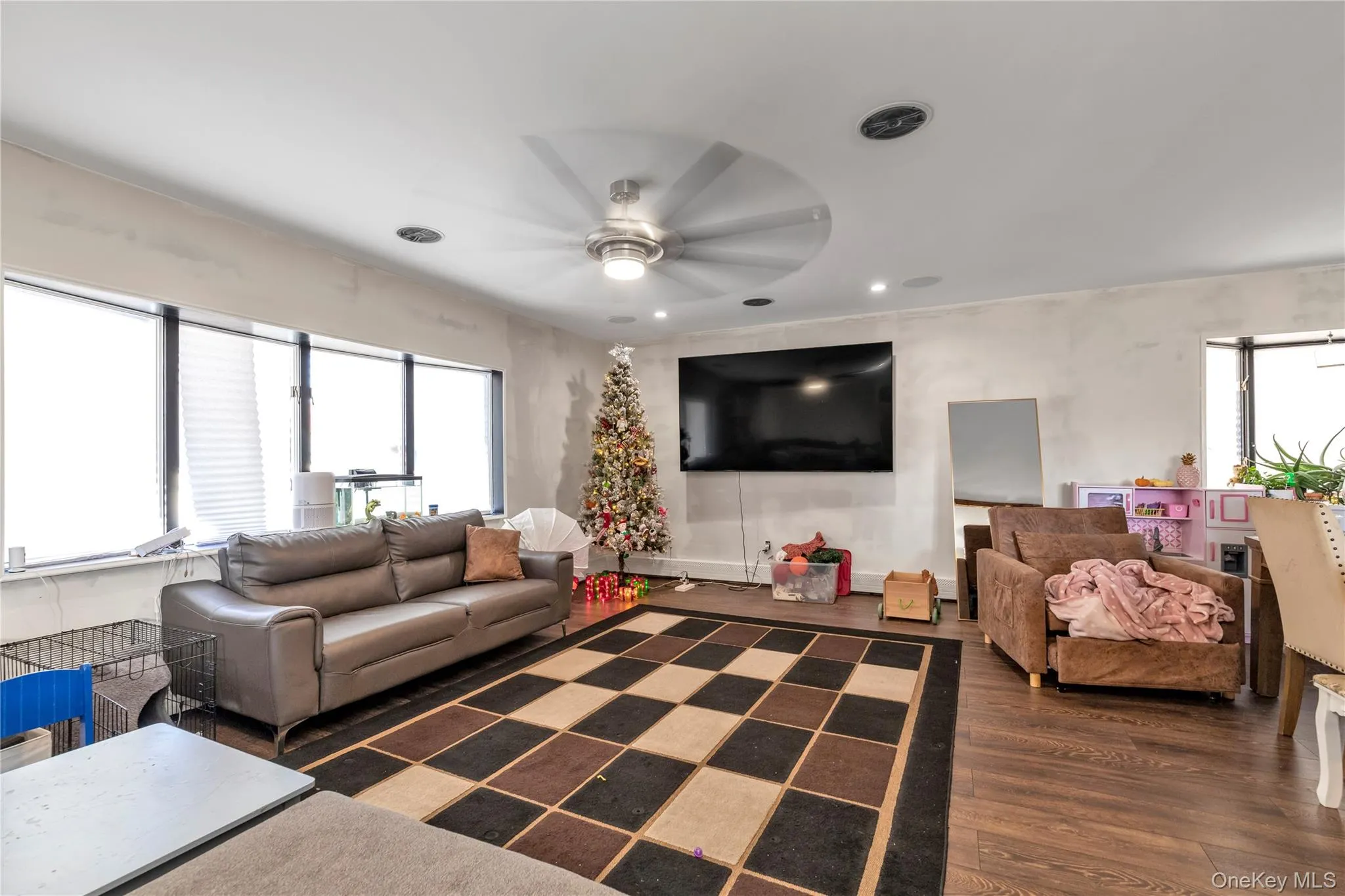 Living room with dark hardwood / wood-style floors and ceiling fan Living room with dark hardwood / wood-style floors and ceiling fan