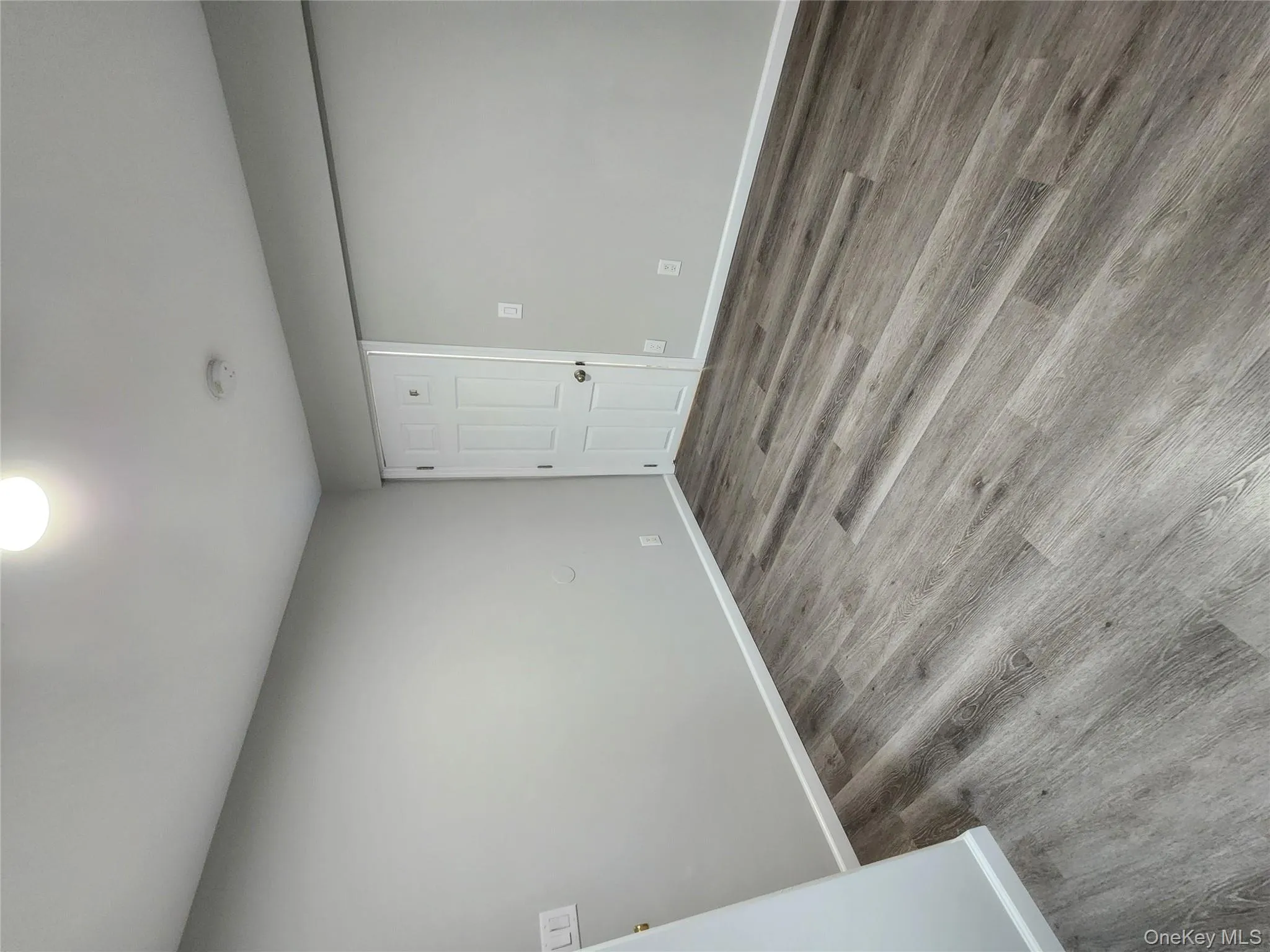 Spare room featuring dark wood-type flooring Spare room featuring dark wood-type flooring