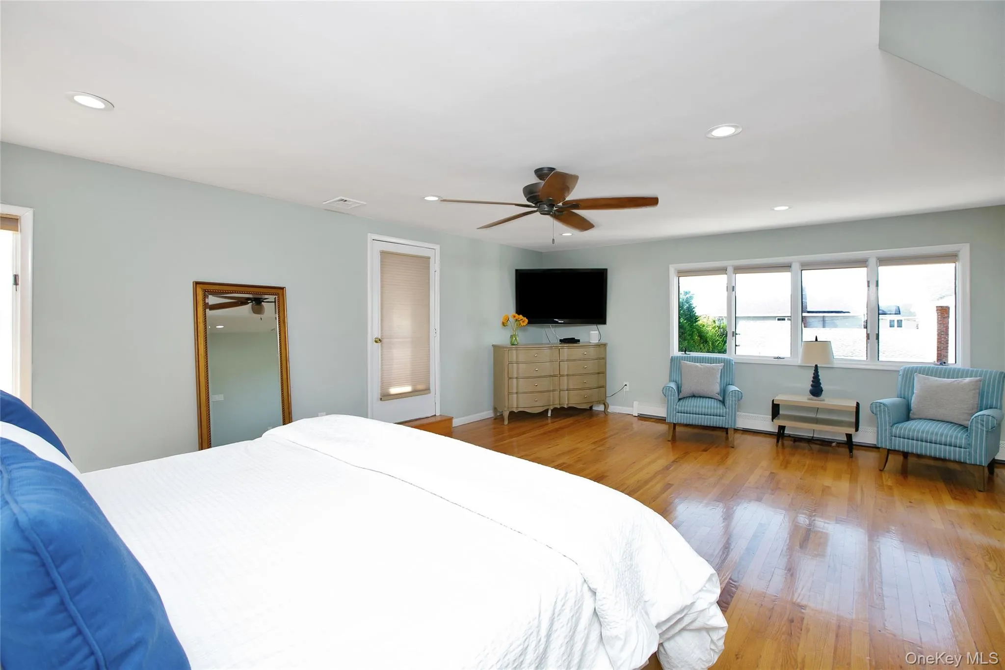Bedroom featuring recessed lighting, light wood-type flooring, and ceiling fan Bedroom featuring recessed lighting, light wood-type flooring, and ceiling fan