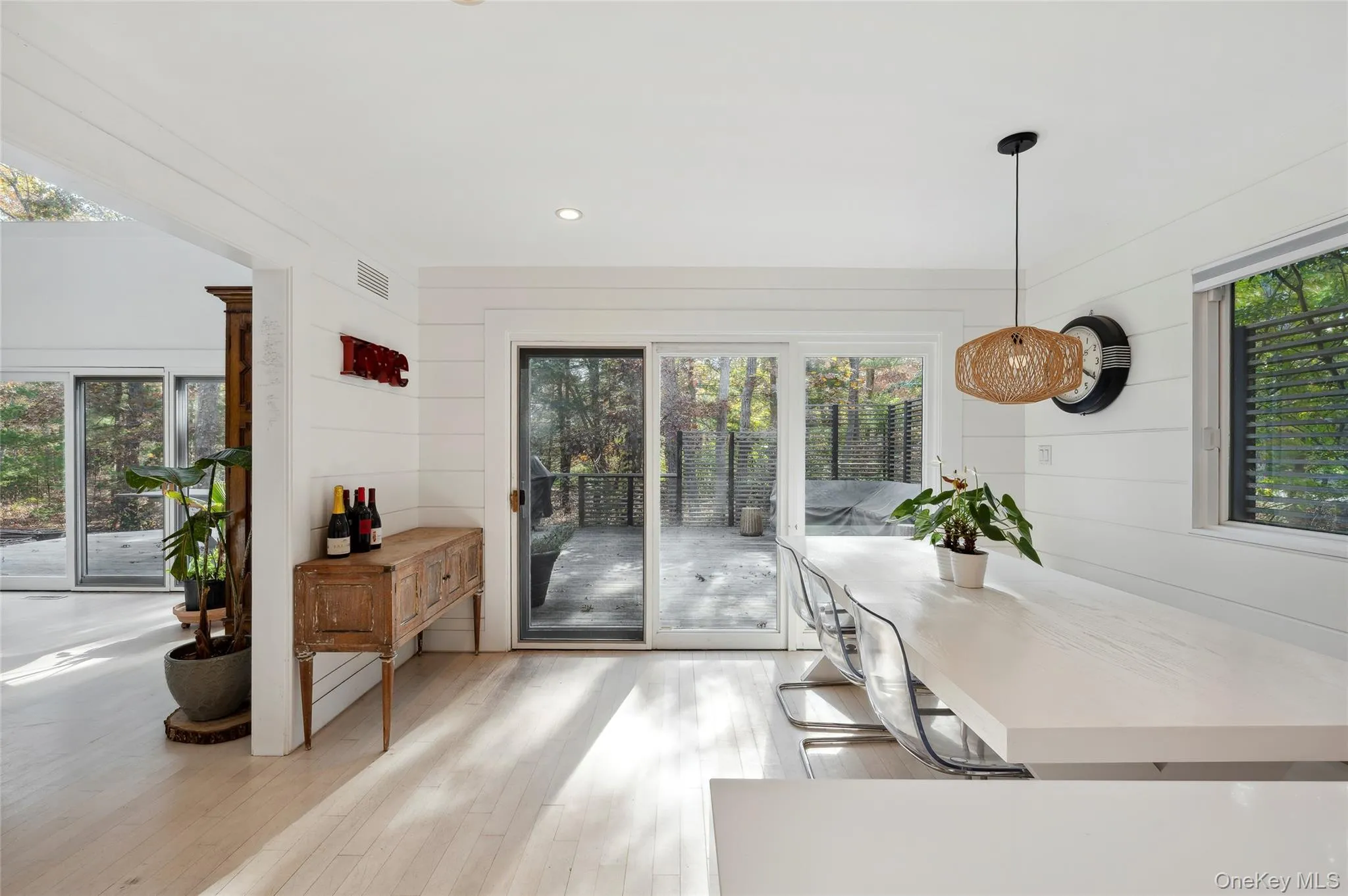 Kitchen with pendant lighting, wooden walls, and light hardwood / wood-style flooring Kitchen with pendant lighting, wooden walls, and light hardwood / wood-style flooring