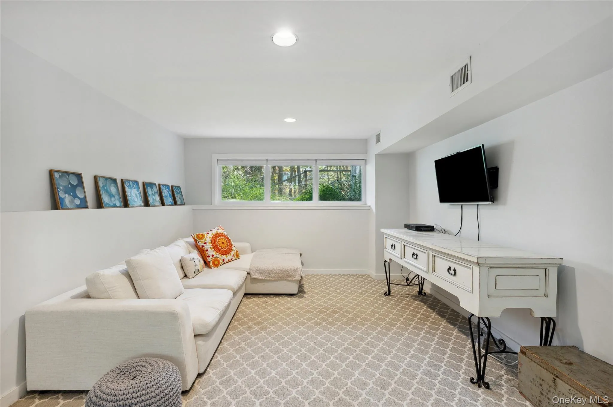 Living room featuring light carpet Living room featuring light carpet
