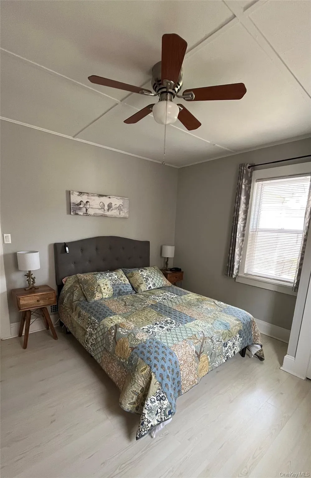 Bedroom featuring wood finished floors and ceiling fan Bedroom featuring wood finished floors and ceiling fan
