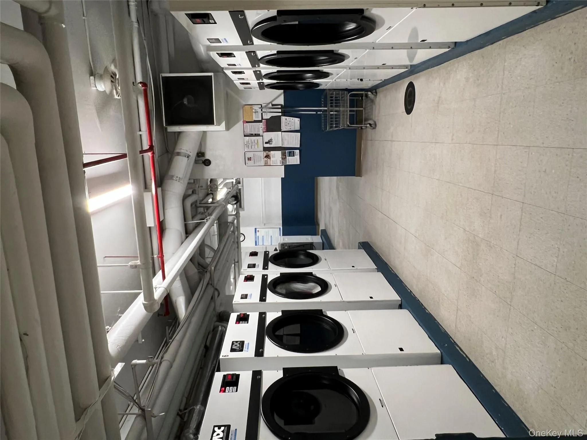 Communal laundry room with washer and clothes dryer Communal laundry room with washer and clothes dryer