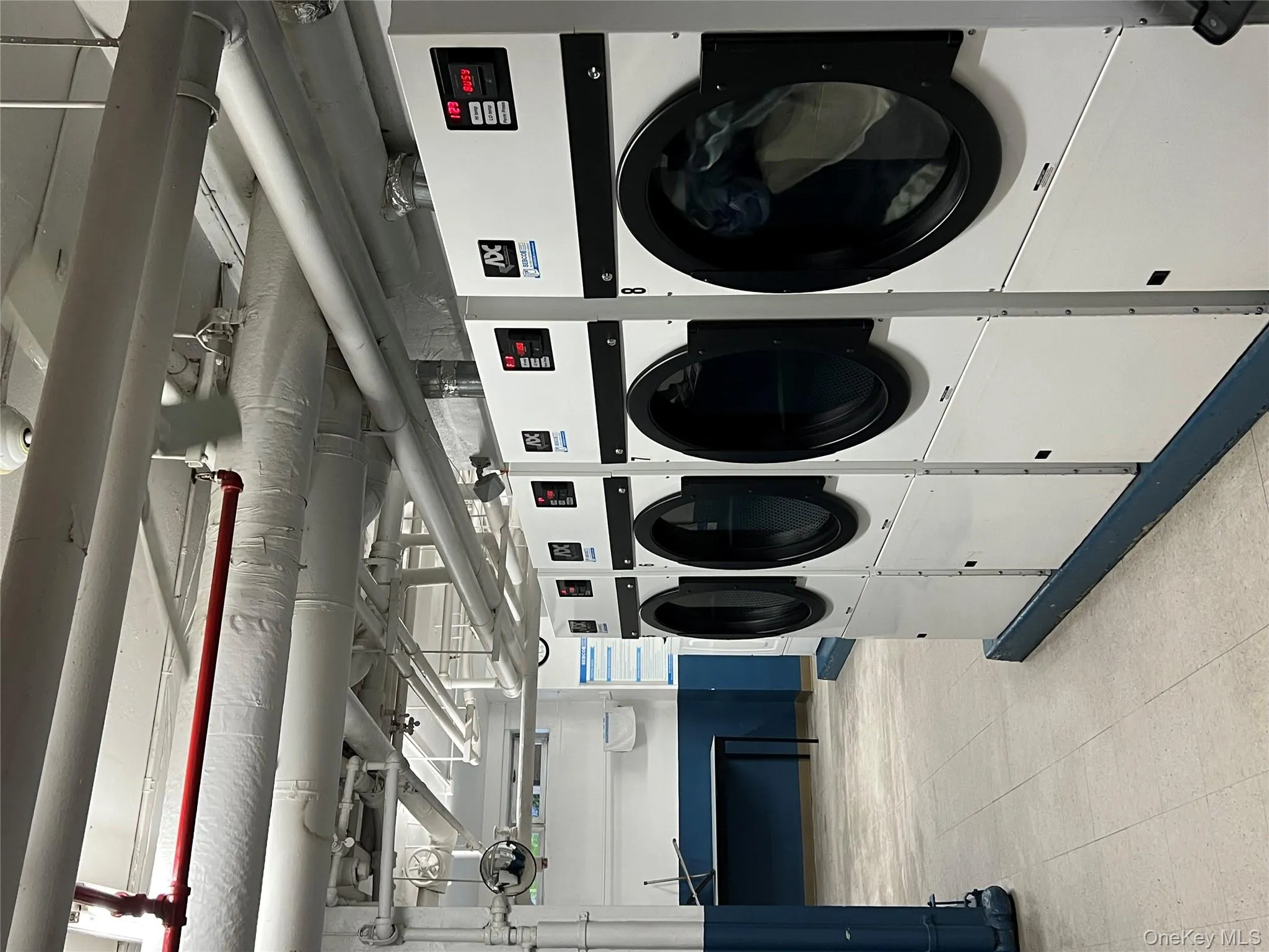 Shared laundry room with separate washer and dryer Shared laundry room with separate washer and dryer