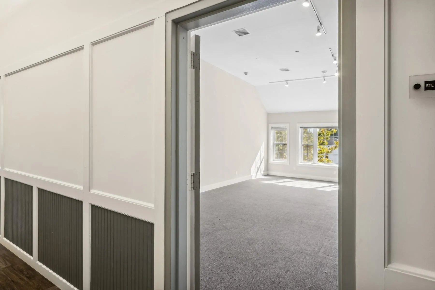 Office featuring carpet, lofted ceiling, and track lighting Office featuring carpet, lofted ceiling, and track lighting