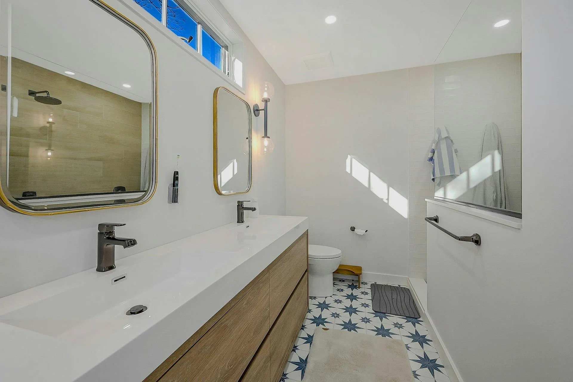 New primary bathroom with tile patterned floors, vanity, toilet, and a tile shower New primary bathroom with tile patterned floors, vanity, toilet, and a tile shower