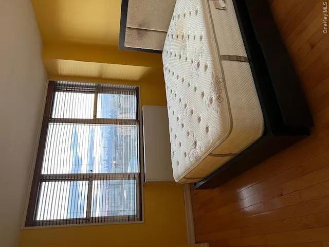 Bedroom featuring dark hardwood / wood-style floors Bedroom featuring dark hardwood / wood-style floors