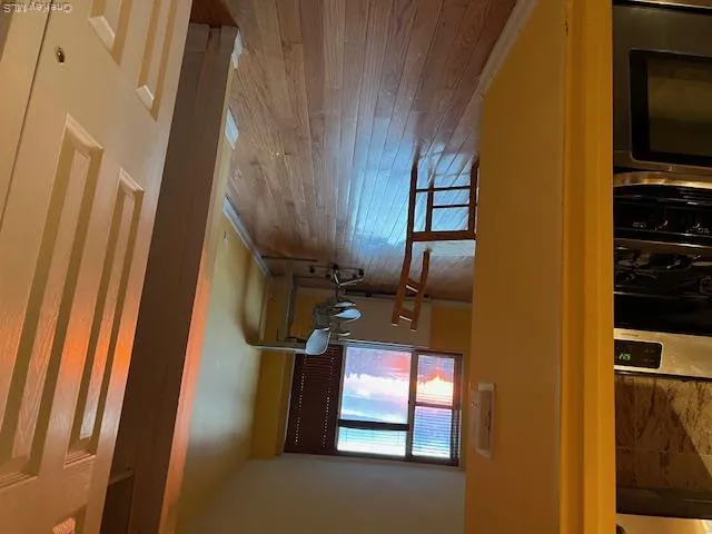 Corridor featuring hardwood / wood-style floors Corridor featuring hardwood / wood-style floors