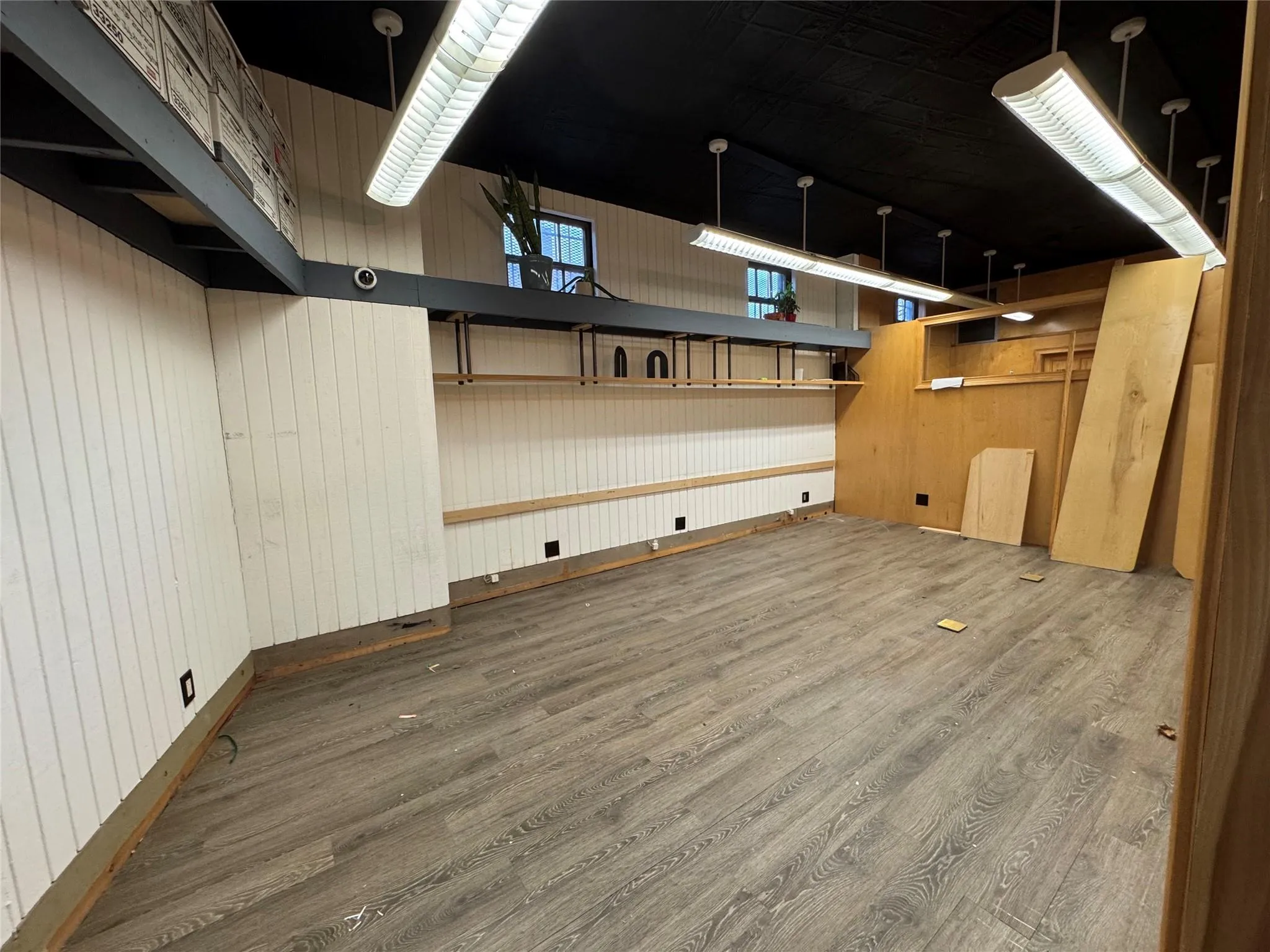 Basement featuring dark hardwood / wood-style flooring and wooden walls Basement featuring dark hardwood / wood-style flooring and wooden walls