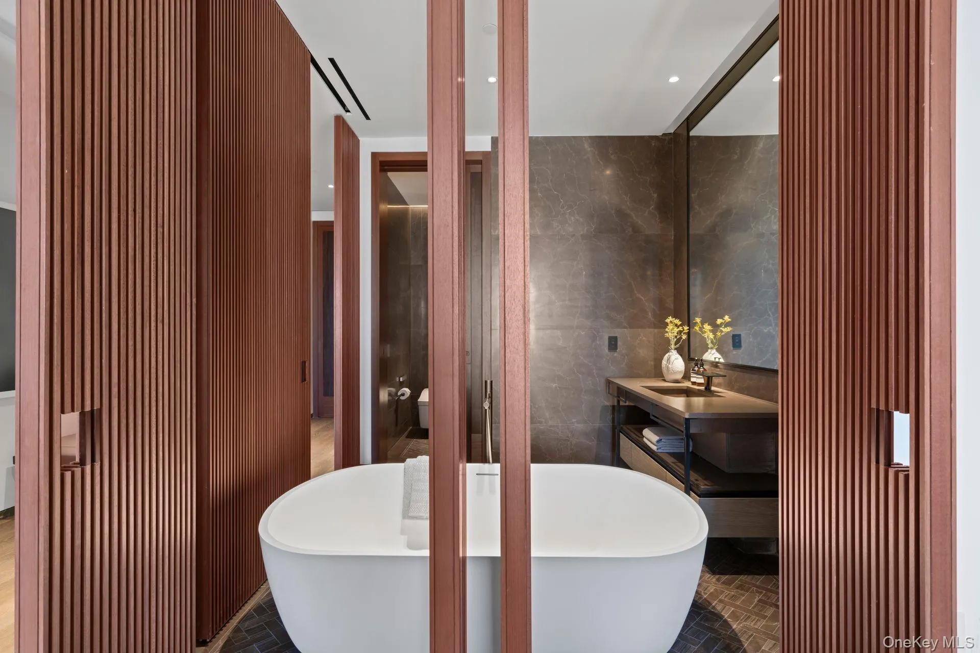 Full bath with a freestanding tub, tile walls, and vanity Full bath with a freestanding tub, tile walls, and vanity