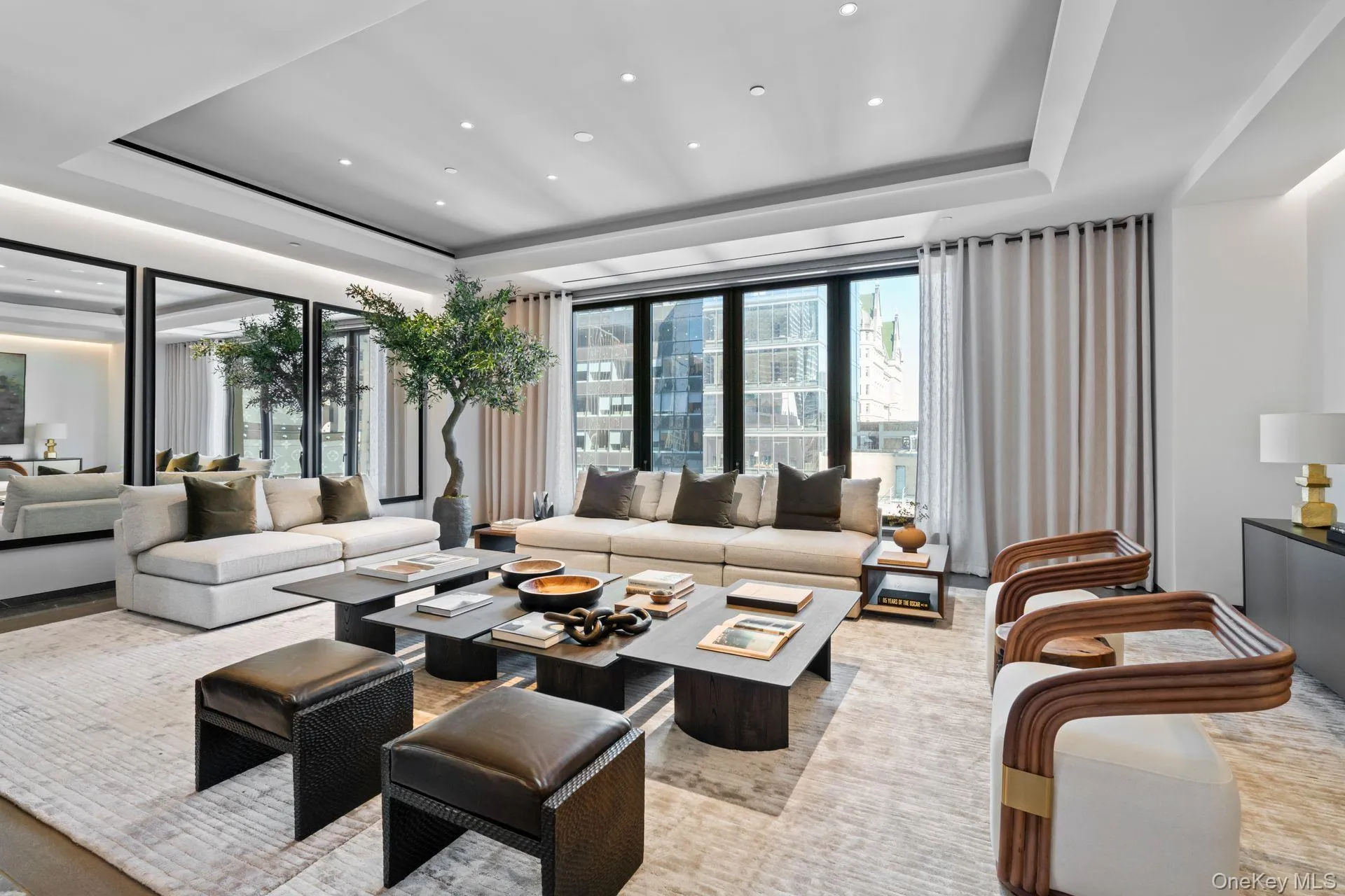 Living room with recessed lighting, a raised ceiling, and floor to ceiling windows Living room with recessed lighting, a raised ceiling, and floor to ceiling windows