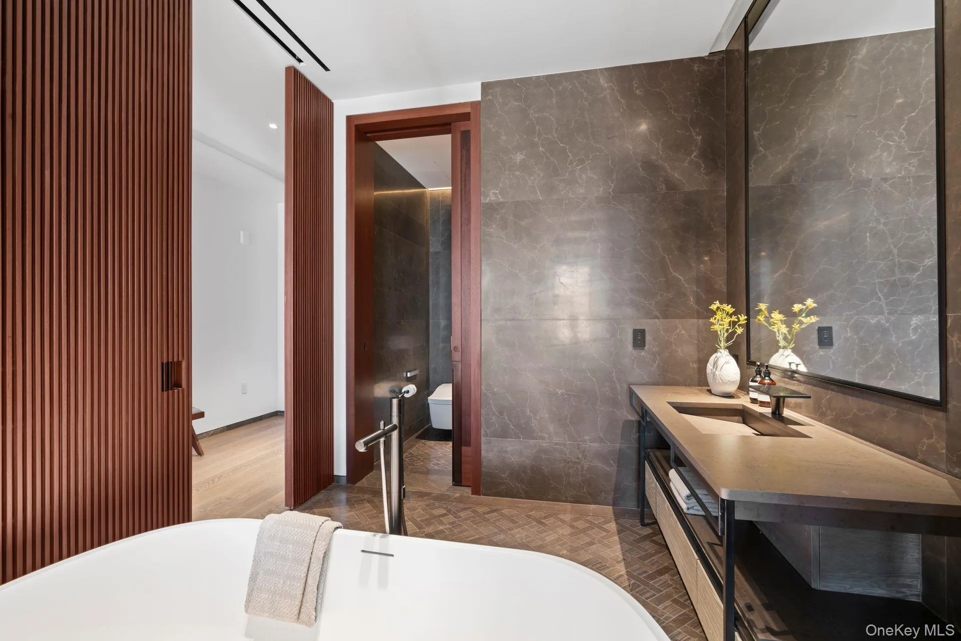 Full bathroom with a soaking tub, visible vents, tile walls, and vanity Full bathroom with a soaking tub, visible vents, tile walls, and vanity