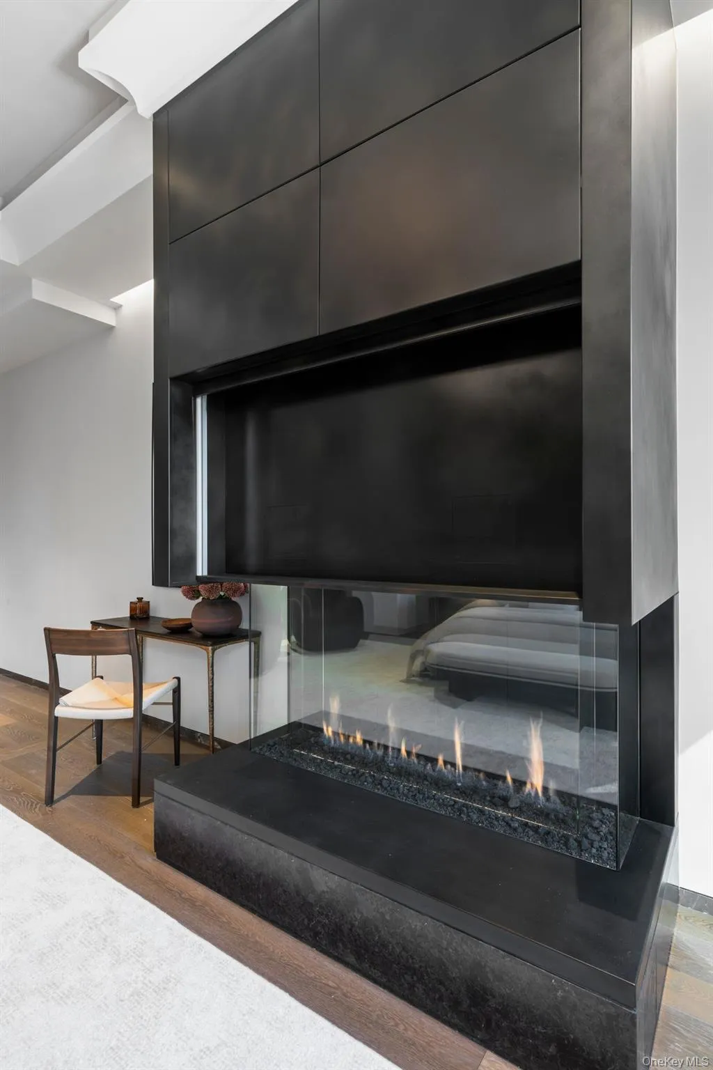 Details with an outdoor fire pit and wood finished floors Details with an outdoor fire pit and wood finished floors