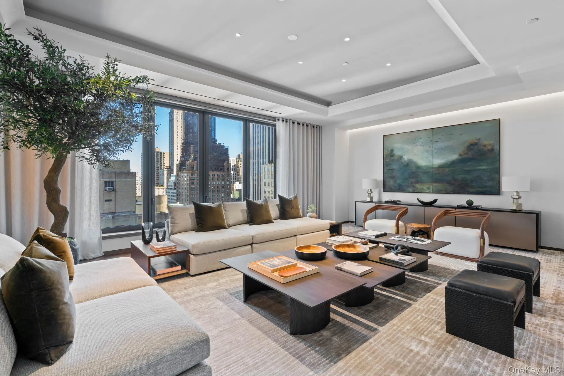 Living area featuring a tray ceiling and recessed lighting Living area featuring a tray ceiling and recessed lighting