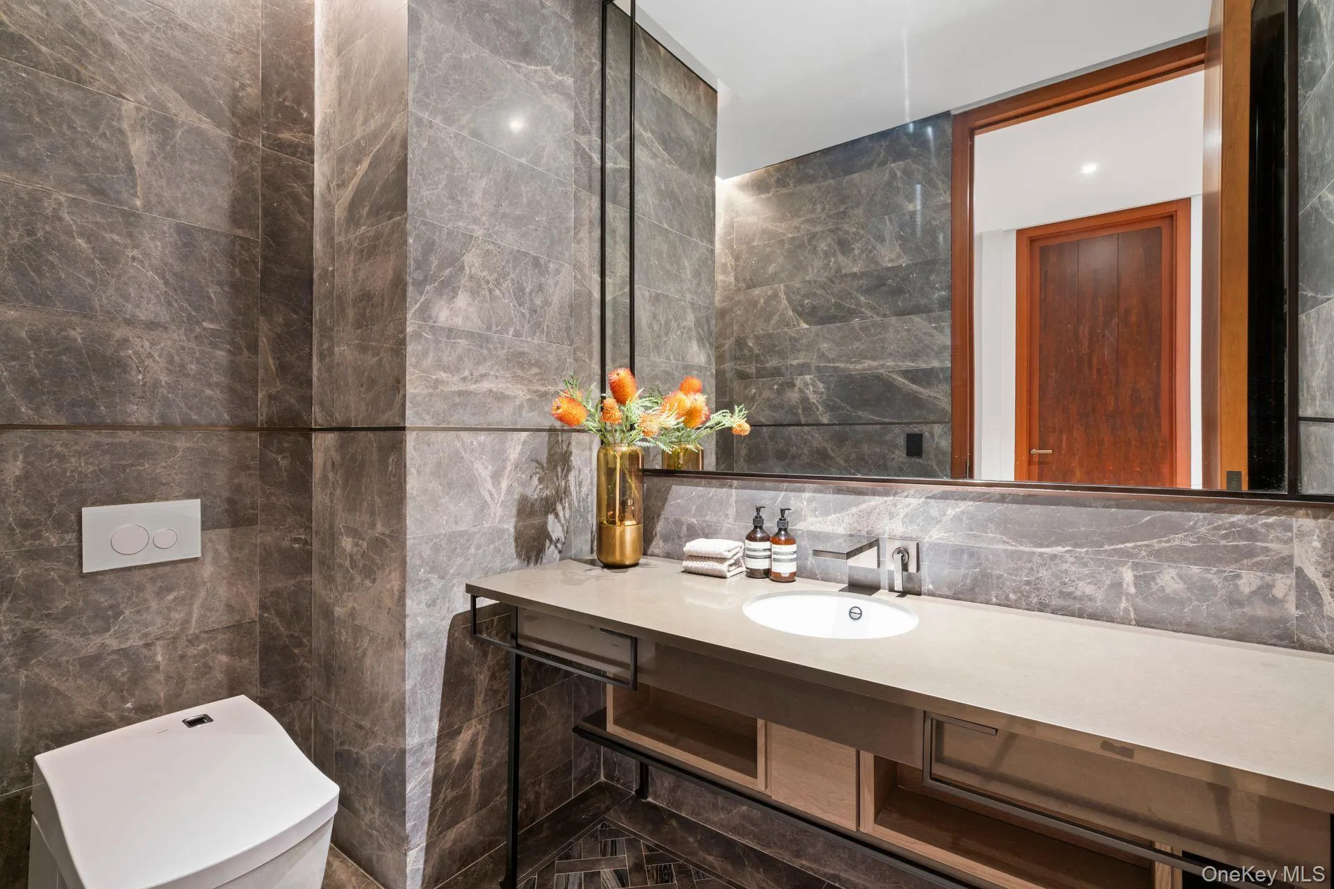 Bathroom featuring decorative backsplash, toilet, tile walls, and vanity Bathroom featuring decorative backsplash, toilet, tile walls, and vanity