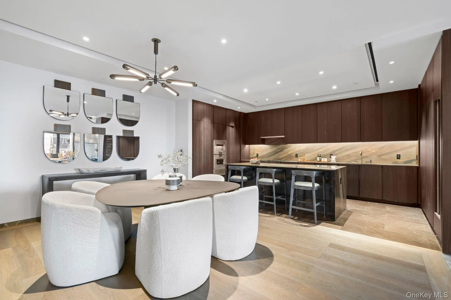 Dining area with an inviting chandelier, light wood-style floors, and recessed lighting Dining area with an inviting chandelier, light wood-style floors, and recessed lighting