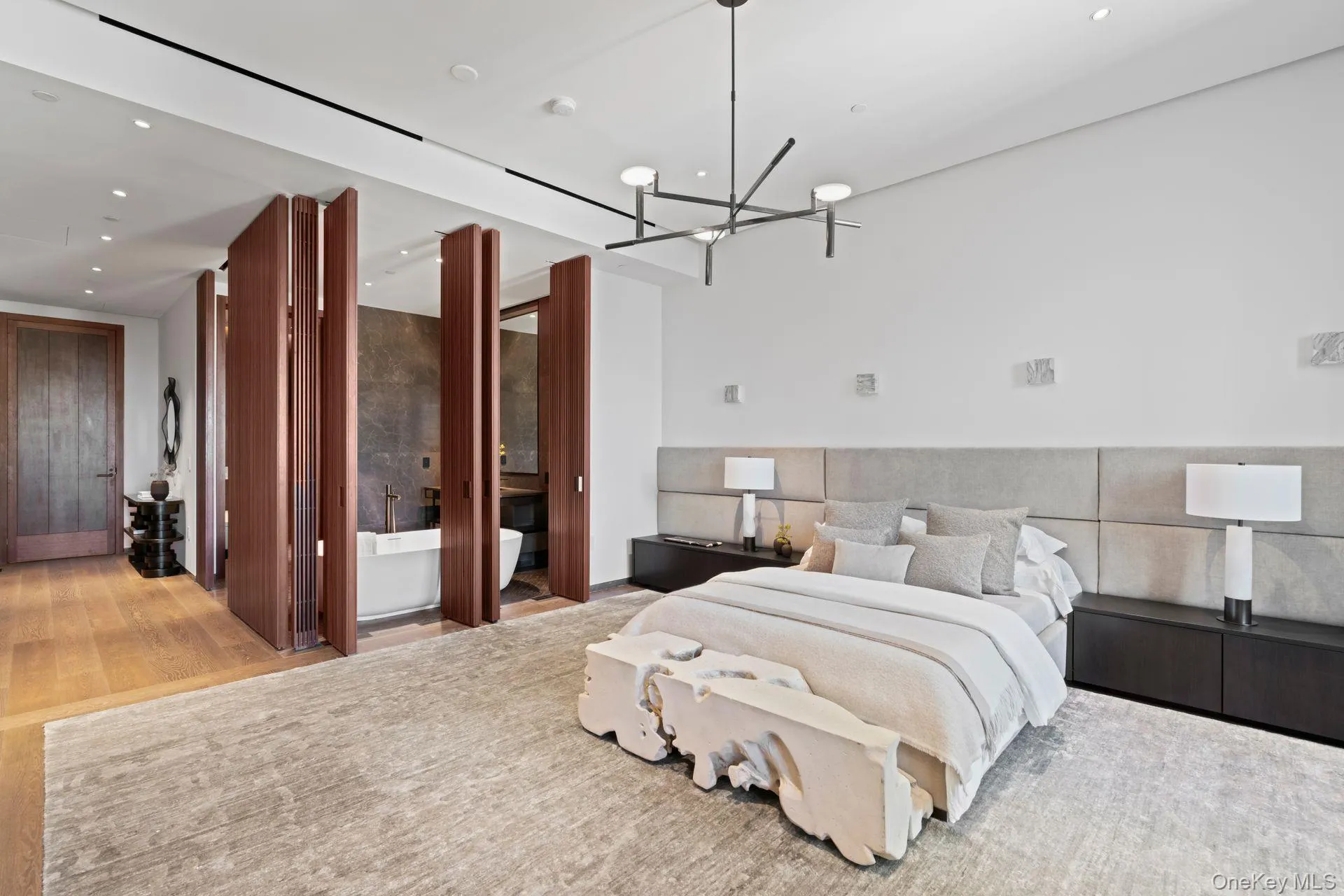 Bedroom featuring a notable chandelier, wood finished floors, and recessed lighting Bedroom featuring a notable chandelier, wood finished floors, and recessed lighting